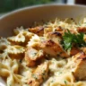 Creamy Chicken Garlic Parmesan Pasta served with herbs.
