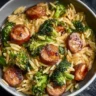 Plate of Chicken Sausage and Broccoli Orzo garnished with herbs