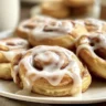 Freshly baked cinnamon roll cookies with icing on top