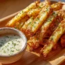 Crispy Air Fryer Parmesan Fries served in a bowl with herbs and spices.