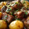 Garlic Butter Beef Bites served with tender potatoes on a plate