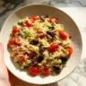Delicious Greek Orzo Salad with fresh vegetables and feta cheese