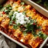 Plate of delicious ground beef enchiladas topped with cheese and salsa