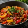 Ground turkey and peppers dish plated with fresh herbs