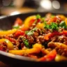 Ground turkey and peppers stir-fry in a vibrant dish, showcasing healthy ingredients.