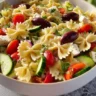 Bowl of Healthy Greek Pasta Salad with veggies and feta cheese