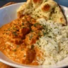 Delicious homemade butter chicken served with rice and naan bread