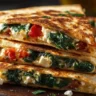 Golden brown spinach and feta quesadillas served with dipping sauce