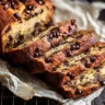 Deliciously moist chocolate chip banana bread sliced on a wooden cutting board