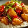 Delicious Sweet Chili Chicken garnished with fresh herbs