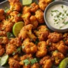 Air Fryer Buffalo Cauliflower pieces served on a plate with dipping sauce.