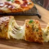 Air fryer pizza baguettes topped with cheese and pepperoni