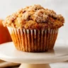 Freshly baked apple pumpkin streusel muffins in a rustic setting