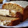 Freshly baked banana bread loaf on a wooden cutting board
