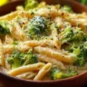Delicious plate of broccoli cheese pasta with creamy sauce and fresh broccoli.