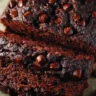 Loaf of chocolate zucchini bread with chocolate chips and zucchini slices
