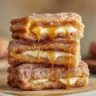 Delicious Churro Cheesecake topped with cinnamon sugar and caramel