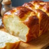 Fluffy Cottage Cheese Cloud Bread on a wooden board with herbs.