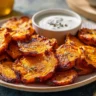 Delicious crispy smashed sweet potatoes garnished with herbs