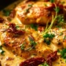 Crock Pot Marry Me Chicken dish garnished with herbs and served with pasta.