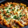 Crockpot baked ziti with cheese and pasta in a serving dish