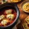 Crockpot Chicken Parmesan served with pasta and garnished with parsley.