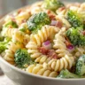Fresh broccoli pasta salad with colorful vegetables and dressing