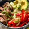 High protein steak fajita bowl with fresh vegetables and tender steak