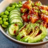 Honey Sriracha Salmon Bowl with colorful vegetables and rice