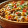 Delicious Mexican White Trash Casserole topped with cheese and spices