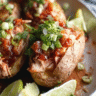 Whole30 Slow Cooker Salsa Chicken served in stuffed potatoes