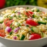 Vibrant orzo pasta salad with fresh vegetables and herbs