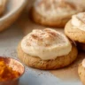 Delicious Pumpkin Cheesecake Cookies on a plate decorated with fall leaves