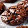 Gourmet brownie cookies stacked on a plate, showcasing their rich chocolate texture.